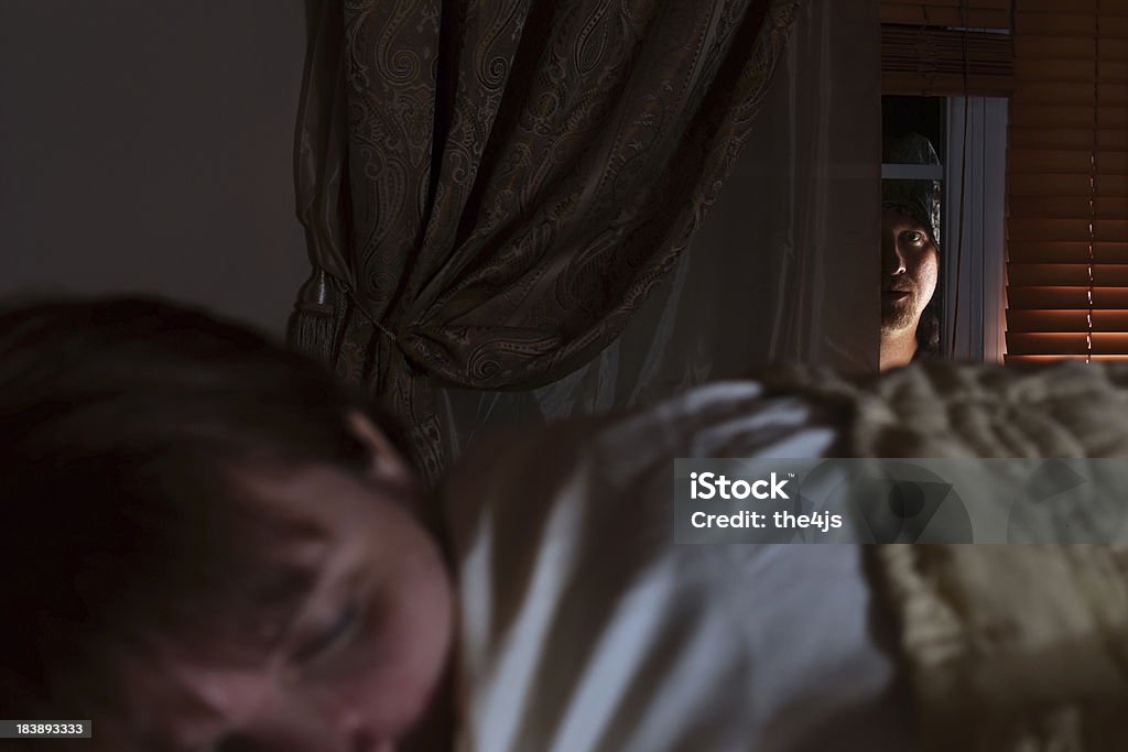 Window Prowler - 38 yo Sleeping Woman A 38 year old woman (though she doesn't look it) sleeping while a prowler peeks through her bedroom window. Stalker - Person Stock Photo