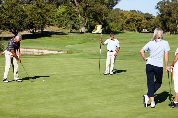 istock Male golfer putting on the green 183893618