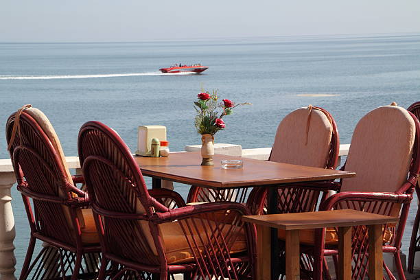 istock table in a restaurant on the sea and boat 183893646
