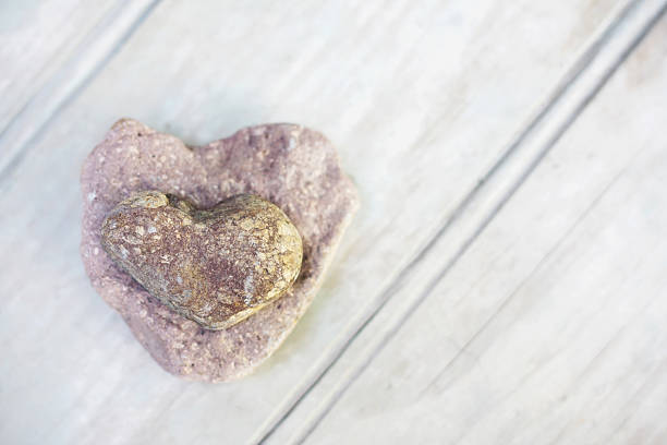 istock Pile of two stones with heart shape on rustic wood 183893650