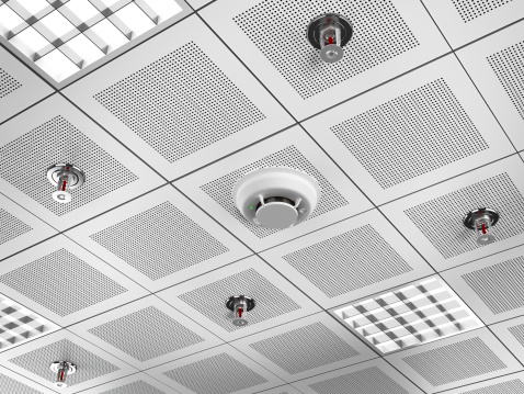 Fire detector and sprinklers mounted on the suspended ceiling.Similar images: