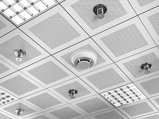 Fire detector and sprinklers Fire detector and sprinklers mounted on the suspended ceiling.Similar images: fire alarm photos stock pictures, royalty-free photos & images