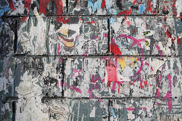 istock Billboard posters on wall ripped and torn paper background 183893928