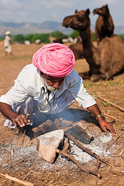 istock Indian men setting up the fire during festival in Pushkar 183894026