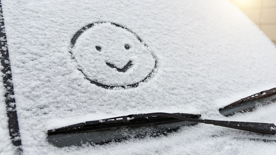 Smiling face drew on car windshield