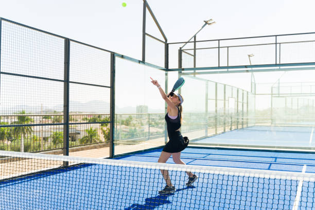 istock Beautiful woman practicing her padel tennis serve 1838965092