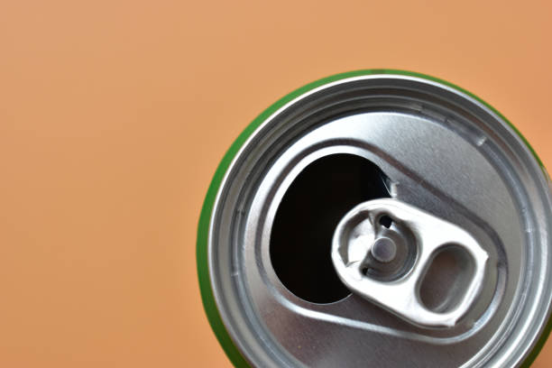 istock aluminum green drink cans on orange background, open cold fresh beverage 1838976701