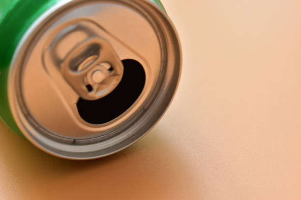 istock aluminum green drink cans on orange background, open cold fresh beverage 1838976703