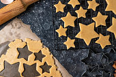 Cutting cookies in the shape of stars from the dough.