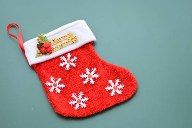 istock red wool winter sock on green background, christmas decoration 1838980914