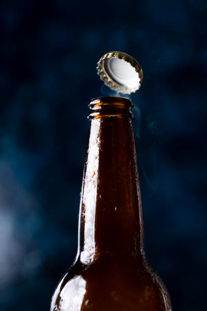 istock Beer bottle with condensation drops and a flying lid 1838992825