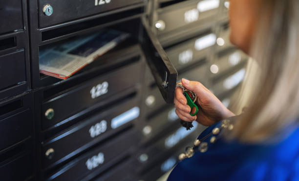 istock Woman checking mailbox in apartment building. 1839015473