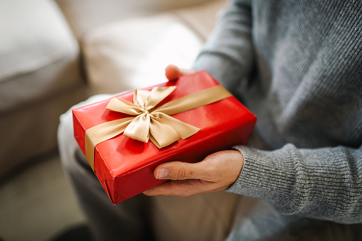 Young man holding a present.