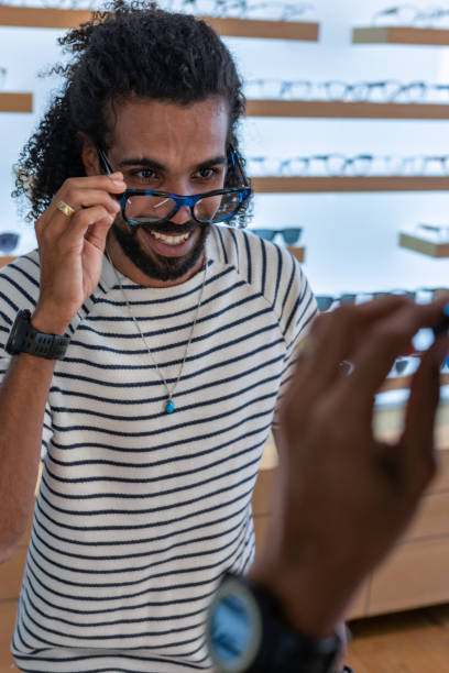 istock A customer buys glasses from an optician 1839024216