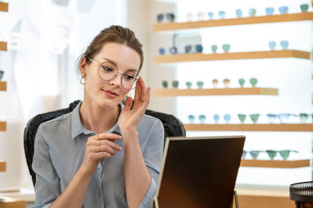 A customer buys glasses from an optician