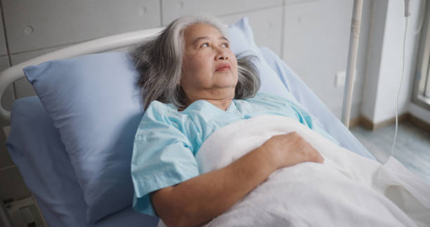 istock Elderly female patient undergoing treatment lying on a hospital bed. 1839069509
