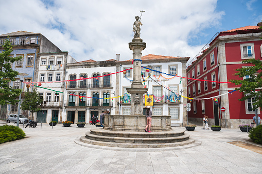 Viana do Castelo, Portugal - June 29 2023: People in historic Vasco da Gama Square and Mercury Water Fountain in Ponte de Lima, selective focus