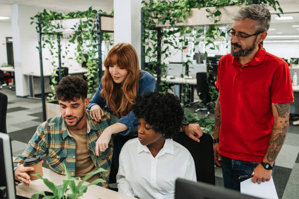 istock Interracial colleagues looking at the laptop and collaborating on project. 1839090099