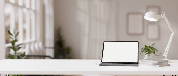 istock Workspace with a white-screen digital tablet mockup on a white table in a modern white room. 1839164166