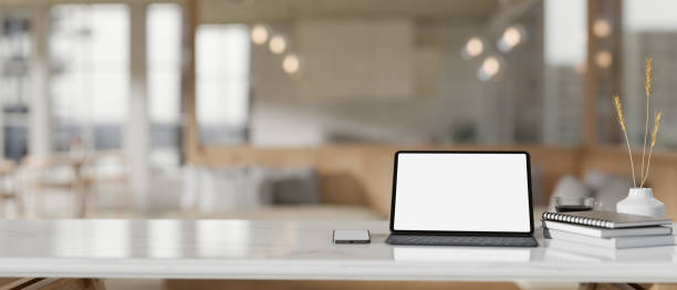 istock A white-screen digital tablet mockup on a white tabletop in a modern beautiful coffee shop. 1839166774