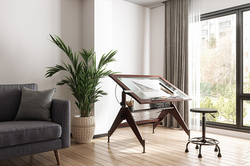 Living Room Interior With Drawing Board, Stool, Sofa And Houseplant