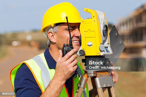 Senior Land Surveyor Working With Tacheometer Stock Photo - Download Image Now - Adult, Adults Only, Agricultural Field