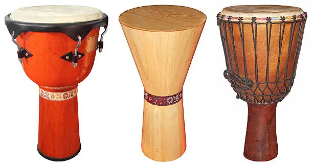 Three wooden jembe drums isolated on white background