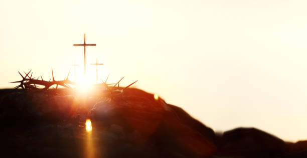 Silhouette of the cross and crown of thorns symbolizing the passion and great trials of Jesus Christ, and bright light and Holy Week and Easter background Silhouette of the cross and crown of thorns symbolizing the passion and great trials of Jesus Christ, and bright light and Holy Week and Easter background the passion of jesus stock pictures, royalty-free photos & images