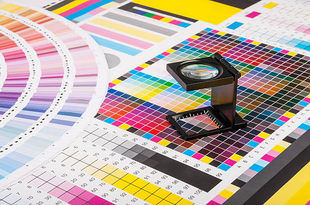 Magnifier and test print The magnifying glass standing on a leaf of the test print cmyk stock pictures, royalty-free photos & images