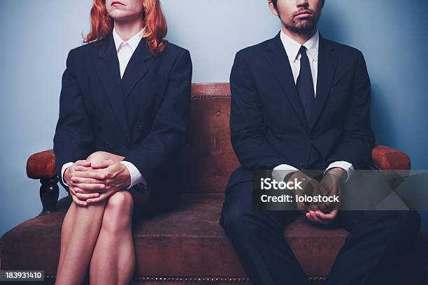 Businessman And Woman Waiting On Sofa In Lobby Stock Photo - Download Image Now - Gender Stereotypes, 20-29 Years, 30-39 Years