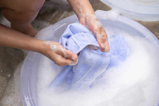 istock Woman washing white clothes by hands. 1839315257