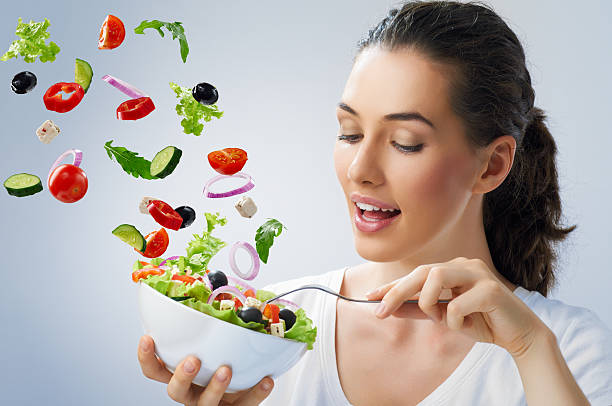 istock Young female tossing healthy salad 183931674