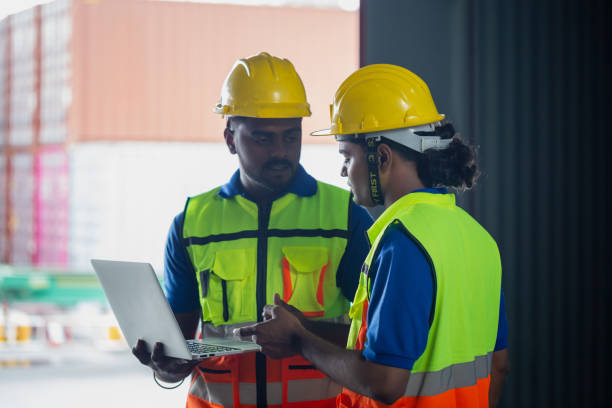 istock Manual workers working in warehouse talking about job, Workers team taking inventory in factory warehouse 1839379286
