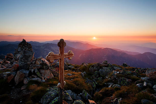 istock sunset over the wooden cross 183940824