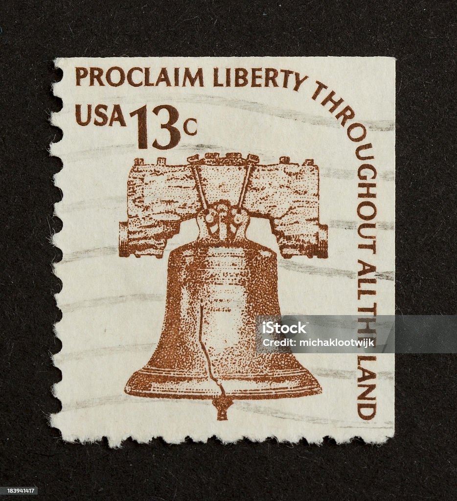 Stamp isolated on black USA - CIRCA 1975: Stamp printed in the USA shows a liberty bell (Proclaim Liberty Throughout All The Land), circa 1975 Antique Stock Photo