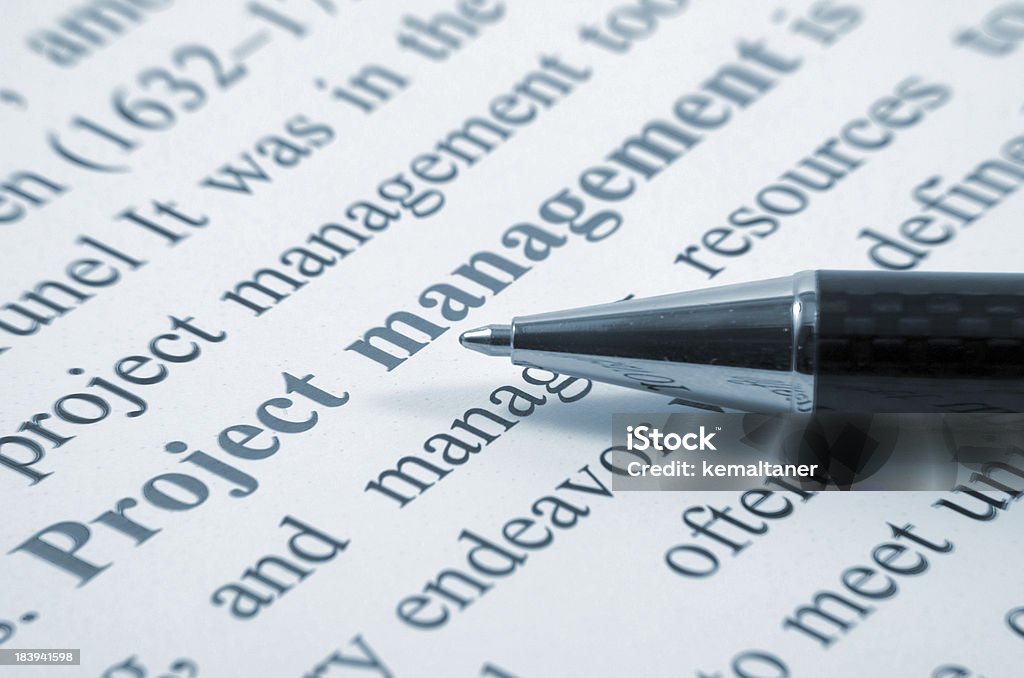 Project management Project management writing and pen closeup Balance Stock Photo