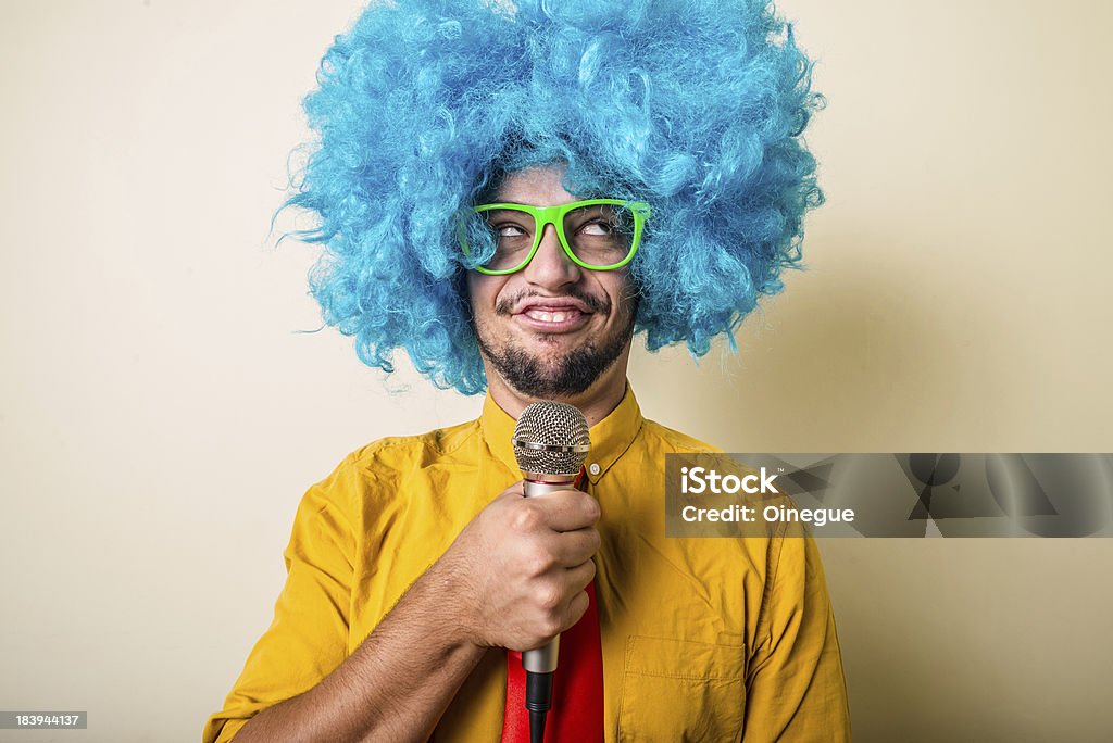 crazy funny young man with blue wig crazy funny young man with blue wig on white background Adult Stock Photo