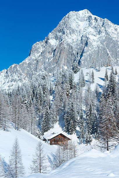 istock Winter rock with fresh fallen snow on top and house. 183944735