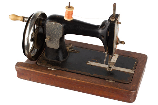 Retro vintage sewing machine isolated on white.