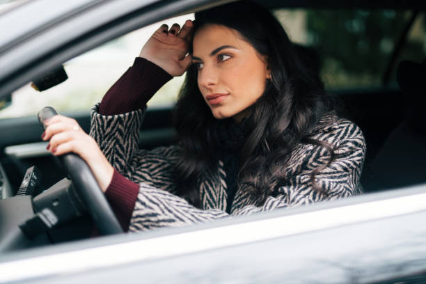 istock Beautiful  woman driving a car 1839459633