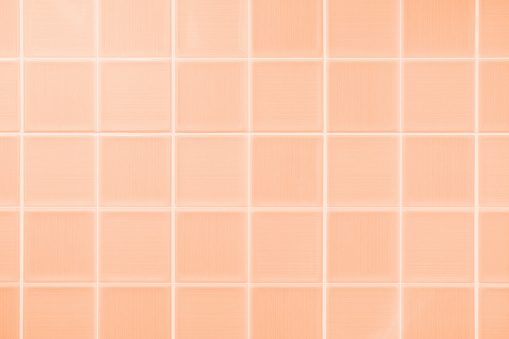 Ceramic tile close up, texture and abstract background, concept color trend 2024 Peach Fuzz.
