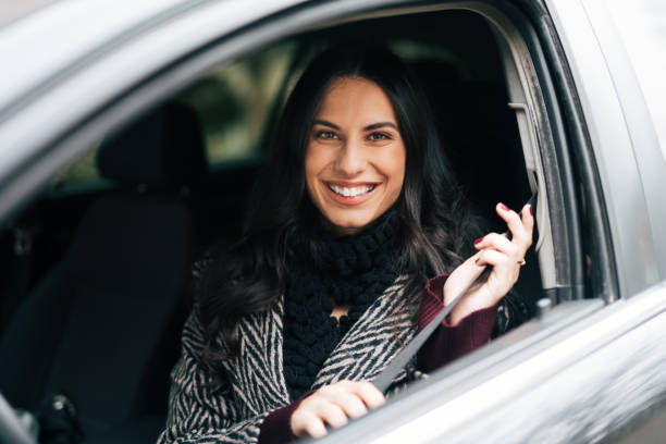 istock Beautiful smiling woman driving a car 1839463844