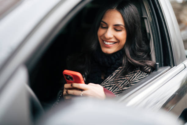 istock Beautiful smiling woman driving a car 1839466032
