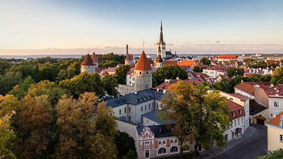 Tallinn, Estonia - July 13, 2023: Tallinn Estonia Old Town Castle on Toompea Hill Cityscape and Fortified Wall in Summer at Sunset Twilight. View over the Old Town of Tallinn, Toompea Hill with Saint Nicholas Church in the background and surrounding Toompea Hill City Castle Fortified Walls, Medieval Towers and Old Town Buildings. Tallinn, Toompea Hill, Old Town Tallinn, Estonia, Northern Europe