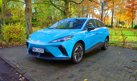 Uelsen, Germany, November 23 2023 An bright blue all electric MG is parked. It's the MG4.