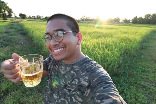 istock happy thai man drink beer 1839571102