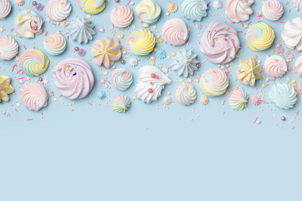 istock Various shape multi colored meringue cookies and small sugar items on blue background with copy space 1839574729
