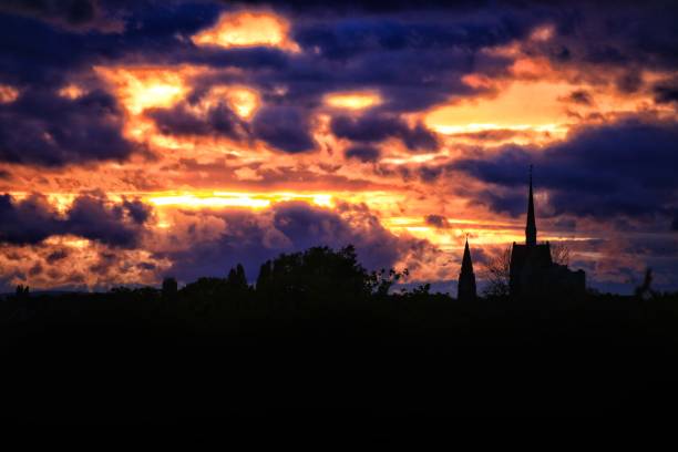 Dramatic evening cloudscape over Hannover with church silhouette.