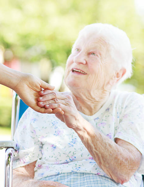 istock Senior woman holding hands with caretaker 183958044