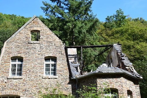 Burgen, Germany - 09/14/2023: a burned house roof with visible damage, old building away from the village itself